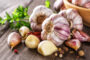 Closeup of Garlic bulbs on wooden table with garlics blur background.A set of fresh garlic on the chest wooden background.